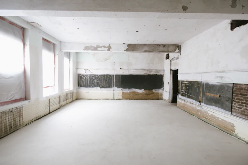 Interior room mid-renovation with exposed walls and new window openings